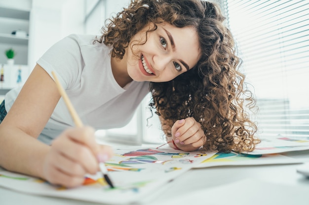 The attractive woman painting a picture