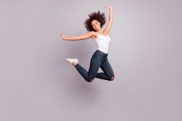 An attractive woman posing while jumping