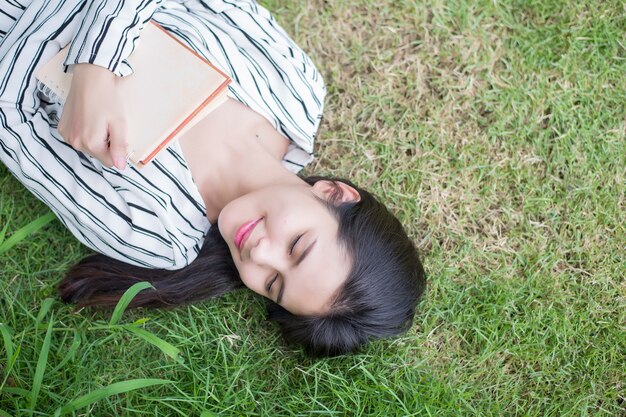 Attractive woman reading a book in the park 