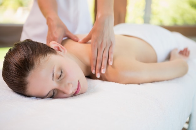 Attractive woman receiving back massage at spa center