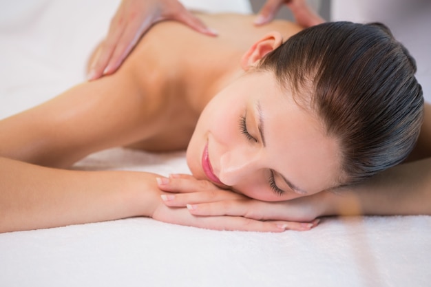 Attractive woman receiving back massage at spa center