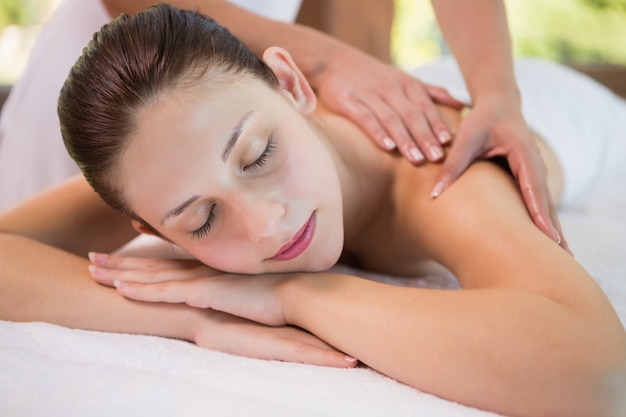 Attractive woman receiving back massage at spa center