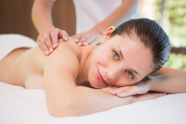 Attractive woman receiving back massage at spa center