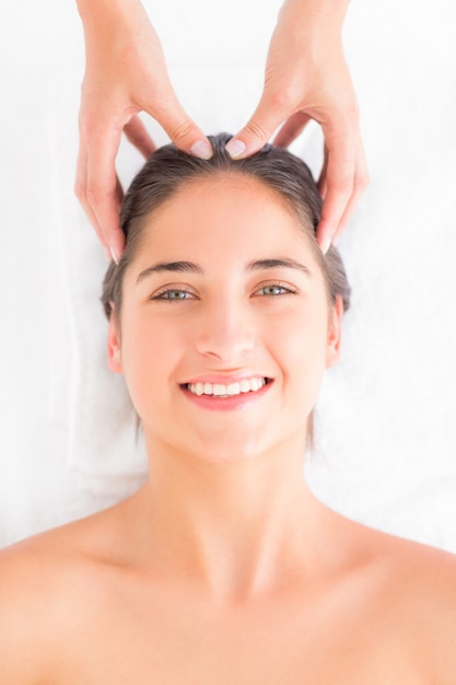 Attractive woman receiving head massage at spa center