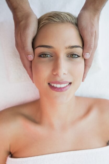 Attractive woman receiving head massage at spa center