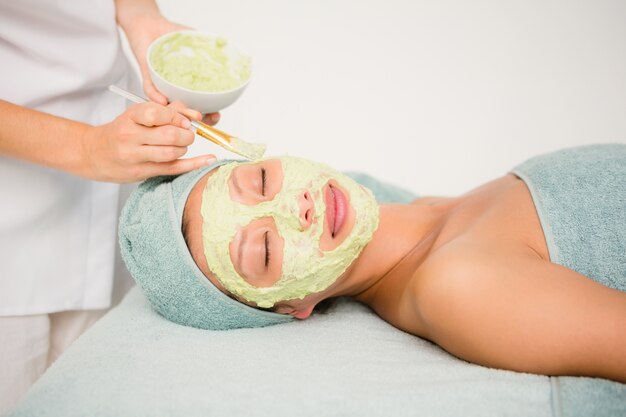 Attractive woman receiving treatment at spa center