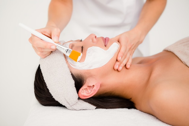 Attractive woman receiving treatment at spa center