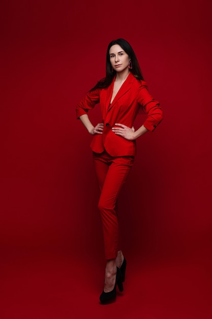 Attractive woman in red suit and black heels