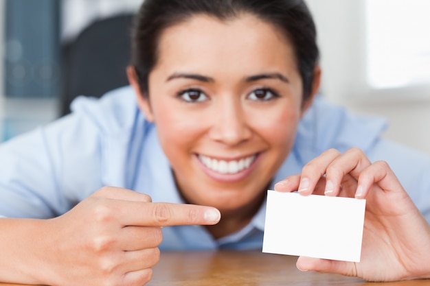 Attractive woman showing her visiting card