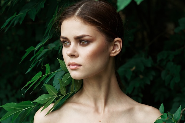 Attractive woman skin care bare shoulders green leaves nature lifestyle