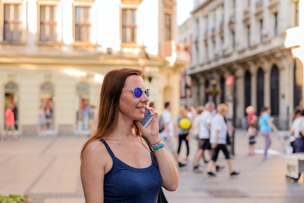 Attractive woman talking on the phone on the street