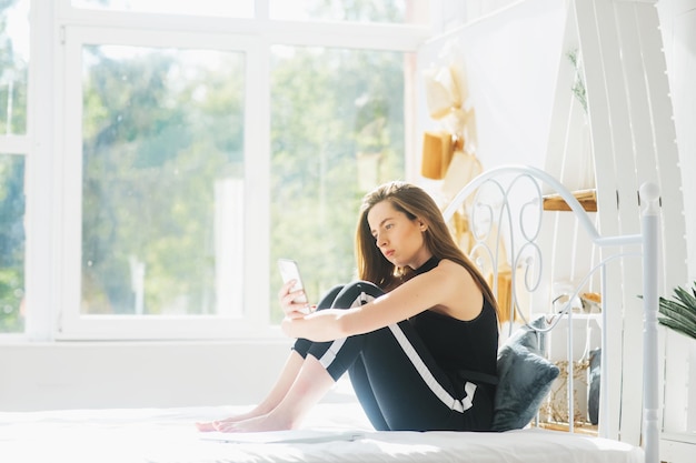 attractive woman using laptop and smiling at morning