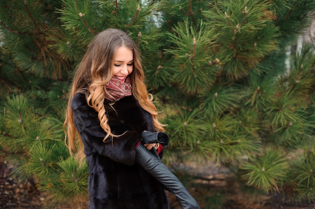 Attractive woman walking in the park in autumn day