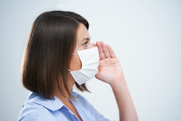 attractive woman wearing protective mask isolated over white background