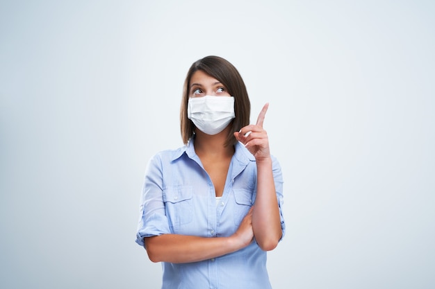 attractive woman wearing protective mask isolated over white background