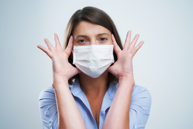 attractive woman wearing protective mask isolated over white background