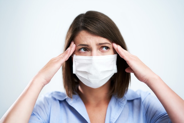 attractive woman wearing protective mask isolated over white background