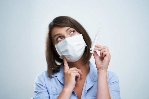 attractive woman wearing protective mask isolated over white background