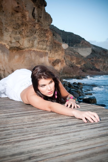 attractive woman in white dress on the seashore