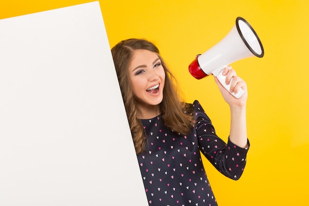 Photo attractive woman with blank placard and loudspeaker