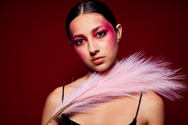 Attractive woman with bright makeup feather charm