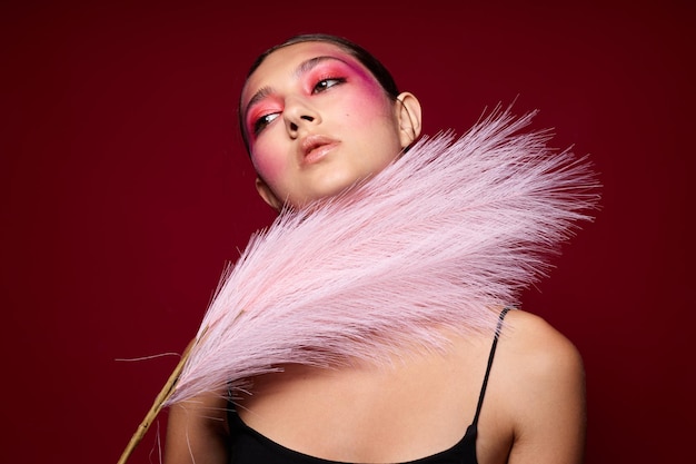 Attractive woman with bright makeup feather charm