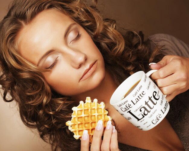 Attractive woman with coffee and cookies