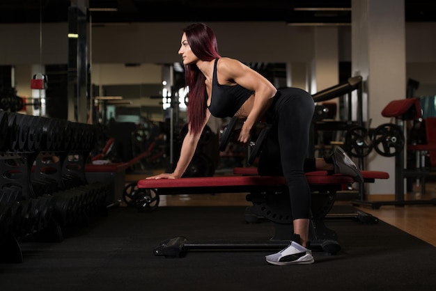 Attractive Woman With Dumbbells Exercising Back