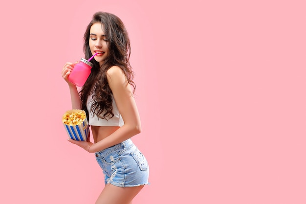 Attractive woman with jar and popcorn