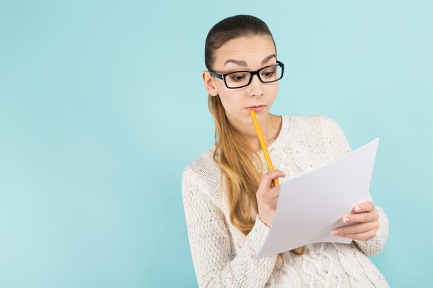 Attractive woman with ponytail and paper sheet