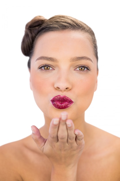 Attractive woman with red lips blowing air kiss