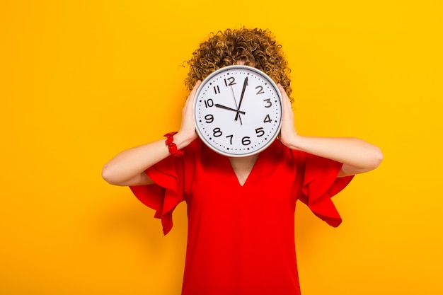 Attractive woman with short curly hair with clocks