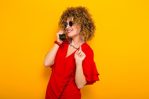 Attractive woman with short curly hair with phone