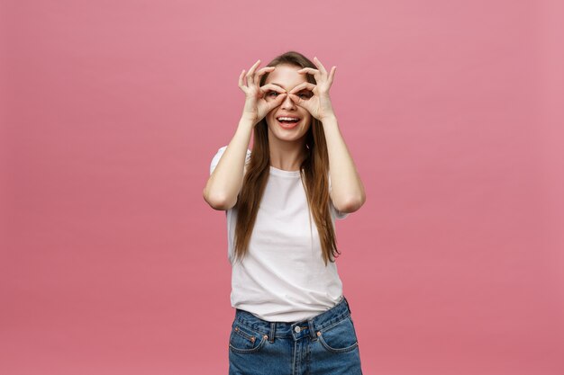 Attractive young adult woman showing ok sign