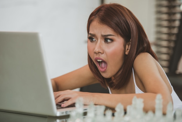 Attractive Young asian woman using laptop at home