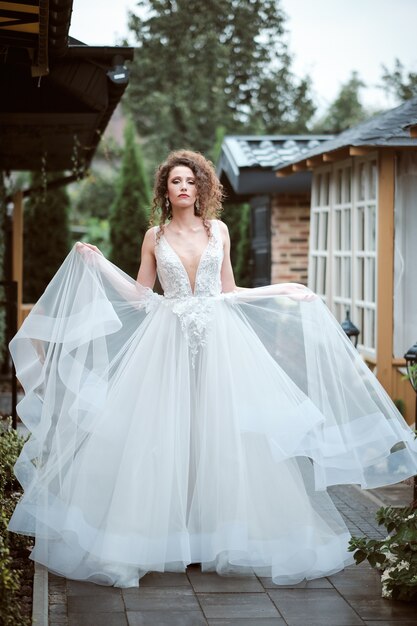 Attractive young bride posing outside