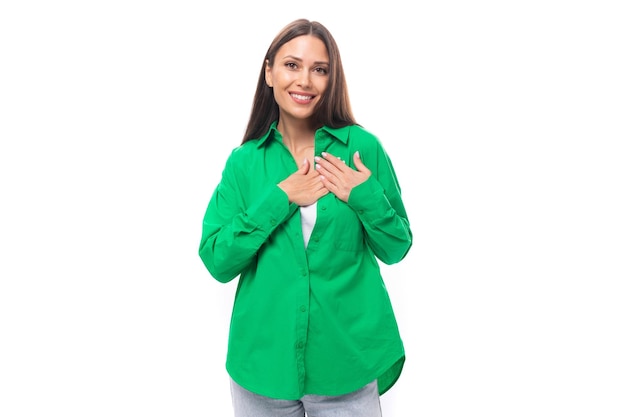 Attractive young brownhaired female model with brown eyes in green shirt isolated on white