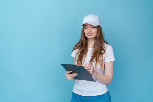 Attractive young caucasian woman in white tshirt cap blue jeans doing a survey