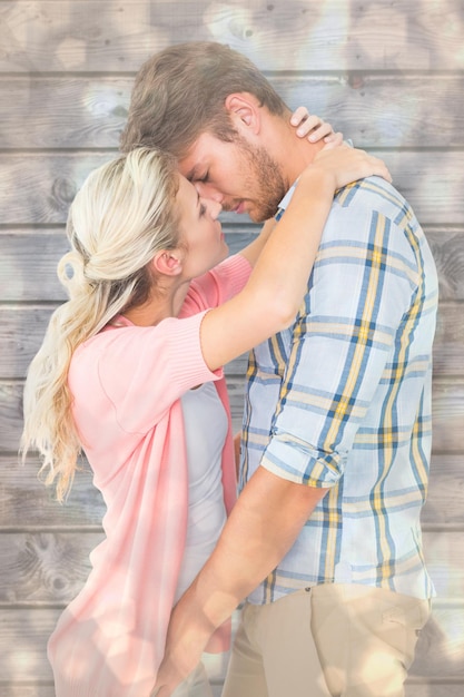 Attractive young couple about to kiss against light glowing dots design pattern