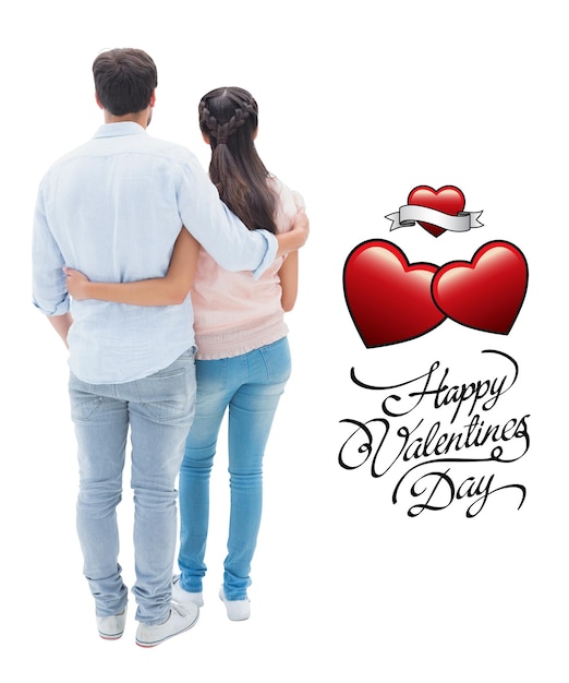 Attractive young couple standing with arms around against valentines day greeting