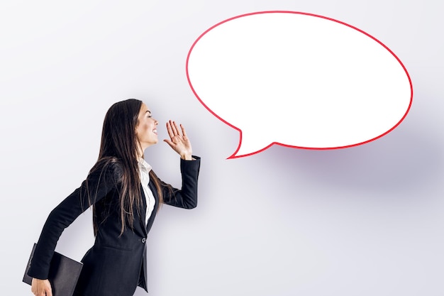 Attractive young european businesswoman with speech bubble on white background Opinion speech and communication concept Mock up place