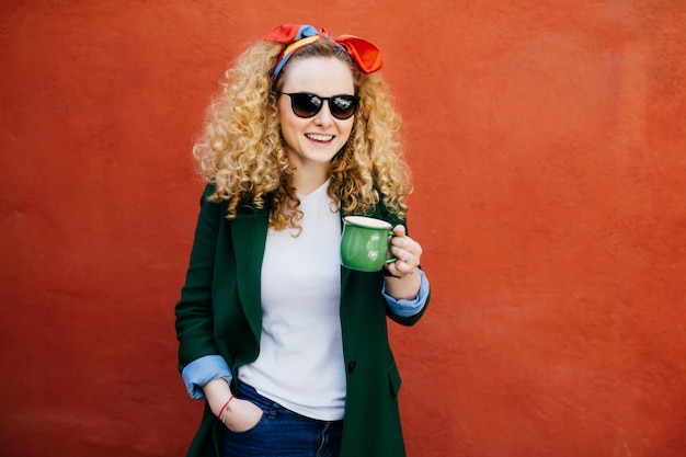 Attractive young European female with headband wearing stylish jacket.