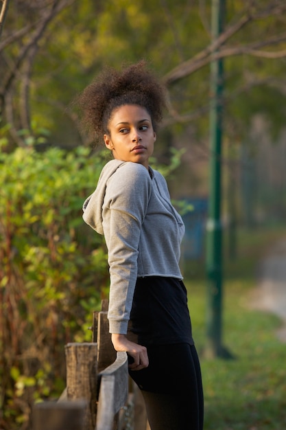 Attractive young exercise woman resting outdoors