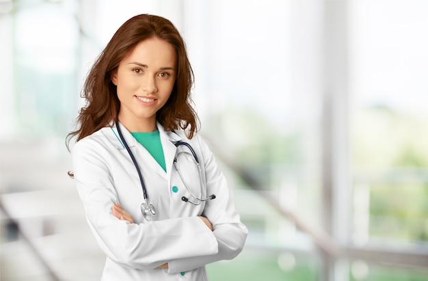 Attractive young female doctor  on background