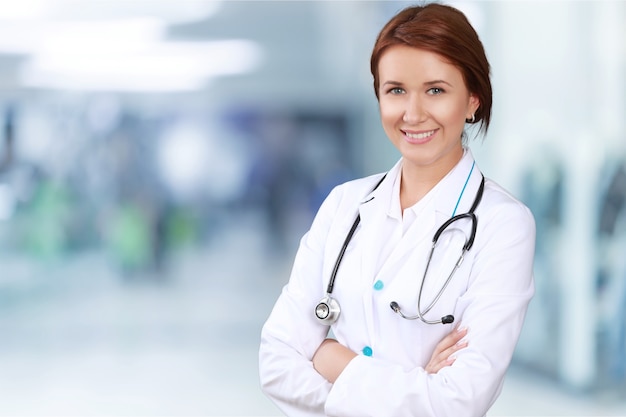 Attractive young female doctor  on background