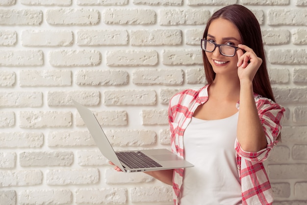 Attractive young girl in casual clothes and eyeglasses.