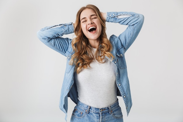 Attractive young girl standing isolated over white , laughing