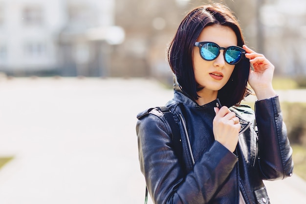 Attractive young girl in sunglasses on sunny day