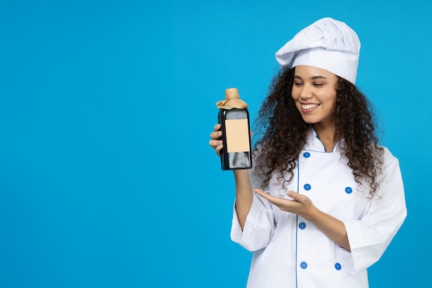 An attractive young girl in the uniform of a chef