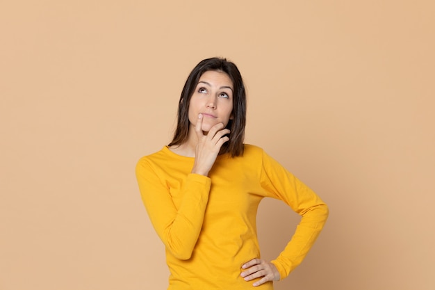 Attractive young girl wearing a yellow T-shirt